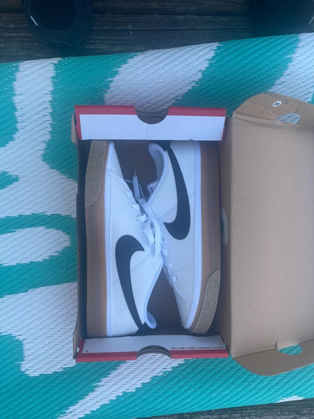Nike White Low-Top Sneakers with Black Swoosh and Gum Midsole
